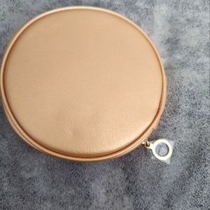 Estee Lauder round gold colored with red interior travel cosmetic/makeup bag